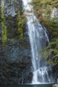 high waterfall in mountains in daylight