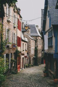 cobblestone street between masonry residential houses